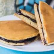 12 Tasty and Easy Cake Recipes Dora cakes on a white tray, kept on wooden surface and some chocolate spread on the background with half dora cake