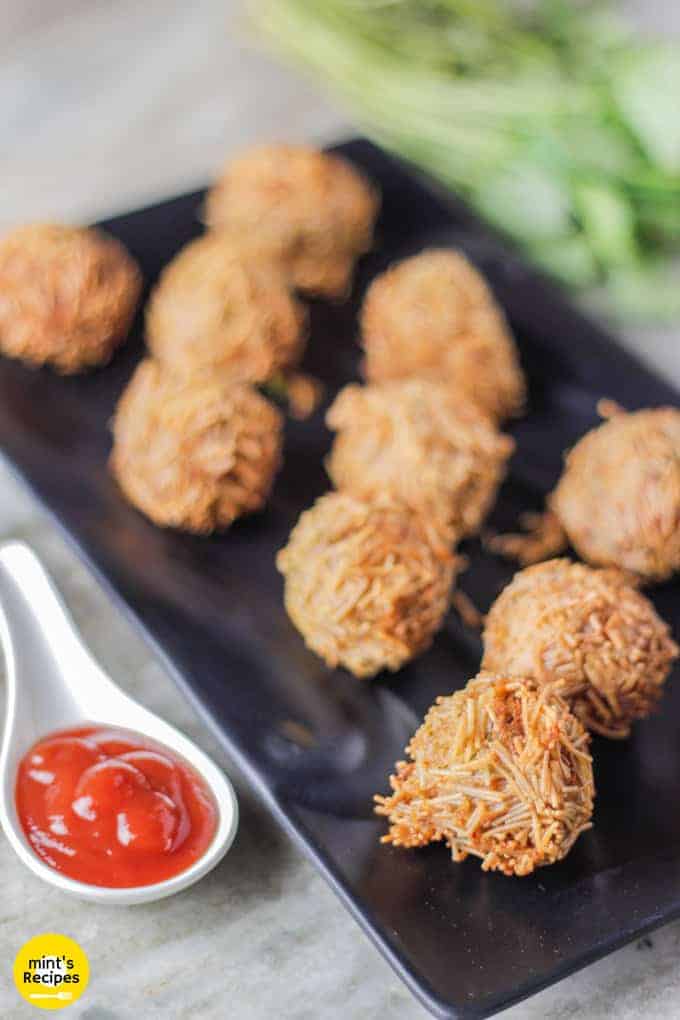 Paneer vermicelli balls made with cottage paneer Paneer vermicelli balls on a black tray