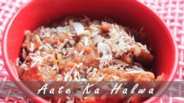 Aate ka halwa on a red bowl with almond and cashew
