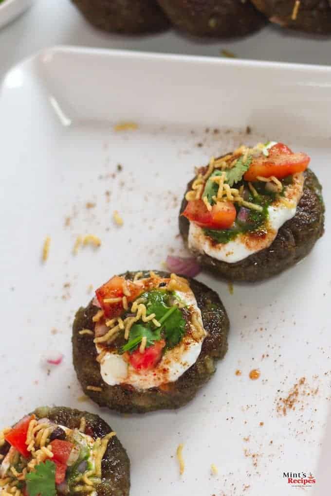 Aloo Palak Tikki Chaat on a white tray 