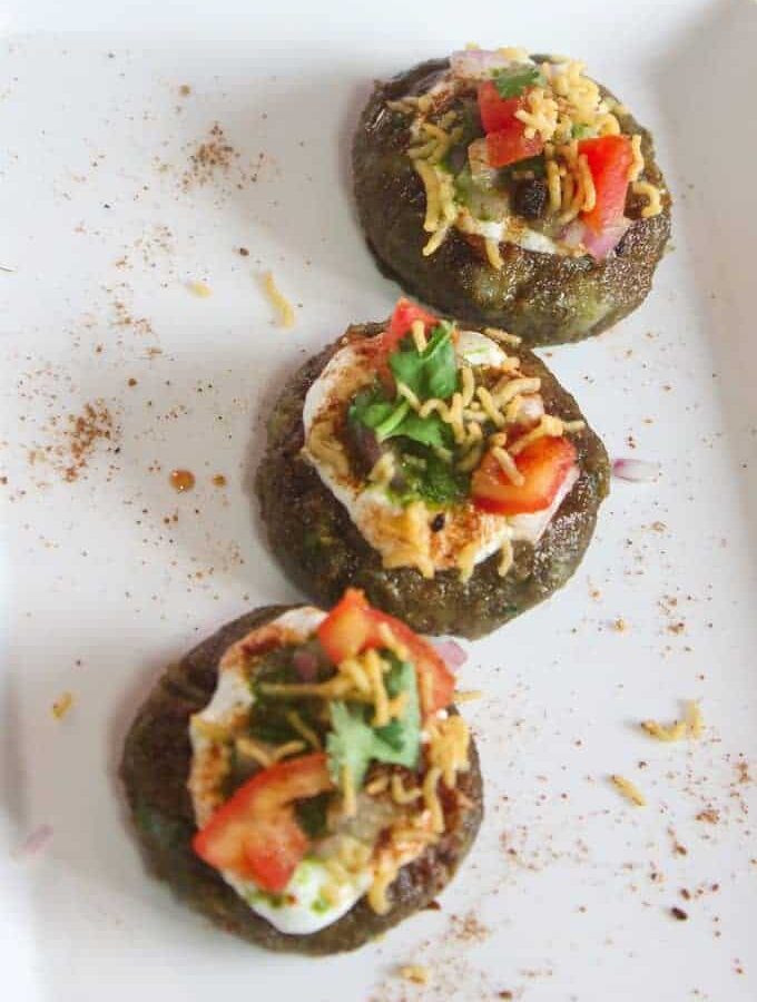 Aloo Palak Tikki Chaat on a white tray