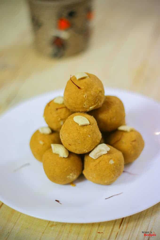 Besan Ke Laddu on a white plate with some cashew