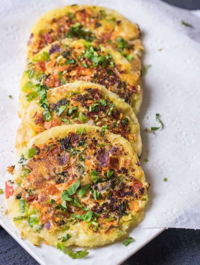 Bread Moongdal Uttapam on a white plate in absorbent paper|