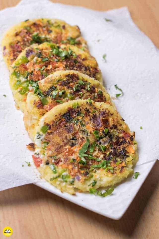 Bread Moongdal Uttapam on a white plate in absorbent paper|