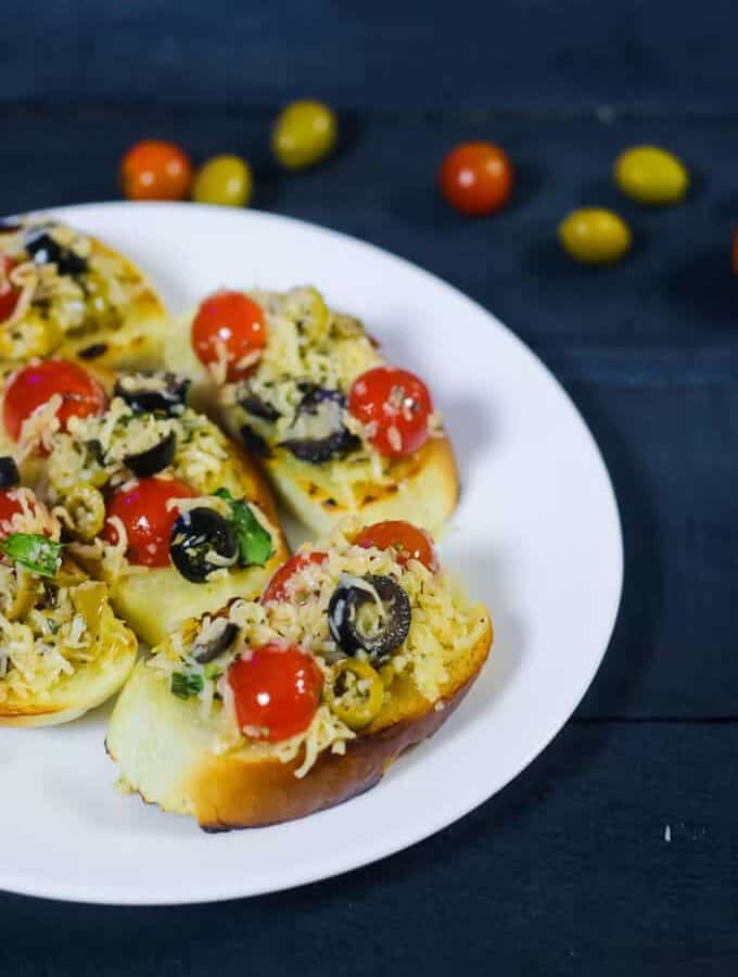 Vegetable Burgers on a black rectangular tray with some onion slices kept on a dark paper surface with dark background |