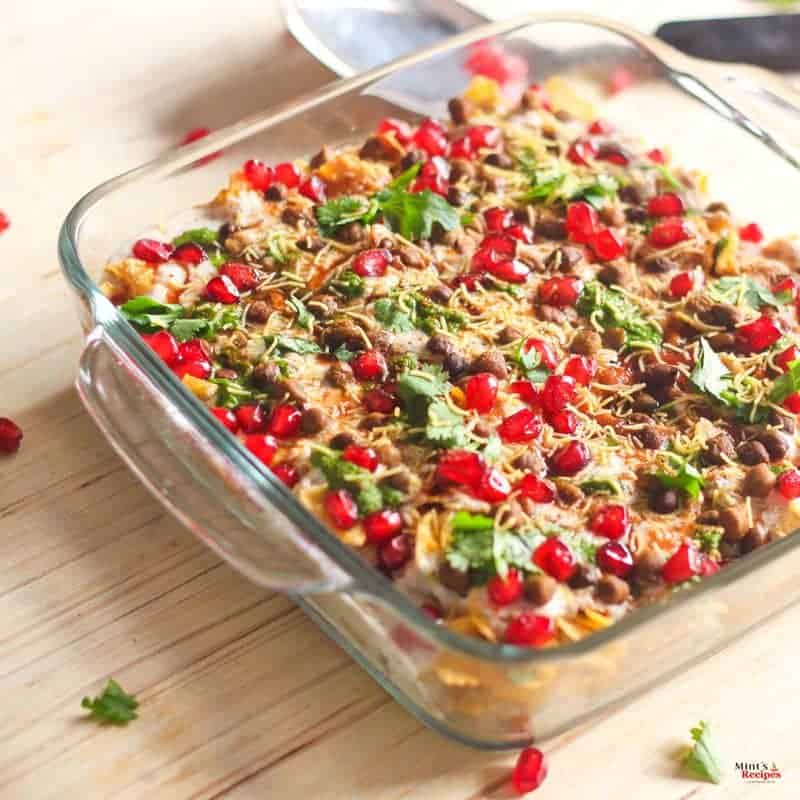 Cornflakes chaat On a transparent borosil bowl garnishing with pomogranate and sev with little coriander leaves |