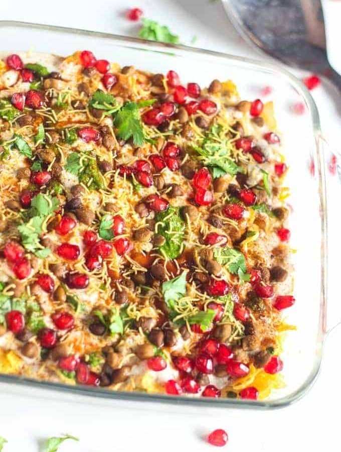 Cornflakes chaat On a transparent borosil bowl garnishing with pomogranate and sev with little coriander leaves |