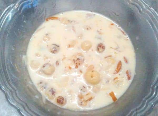 Makhana kheer on a transparent bowl with garnishing of almonds