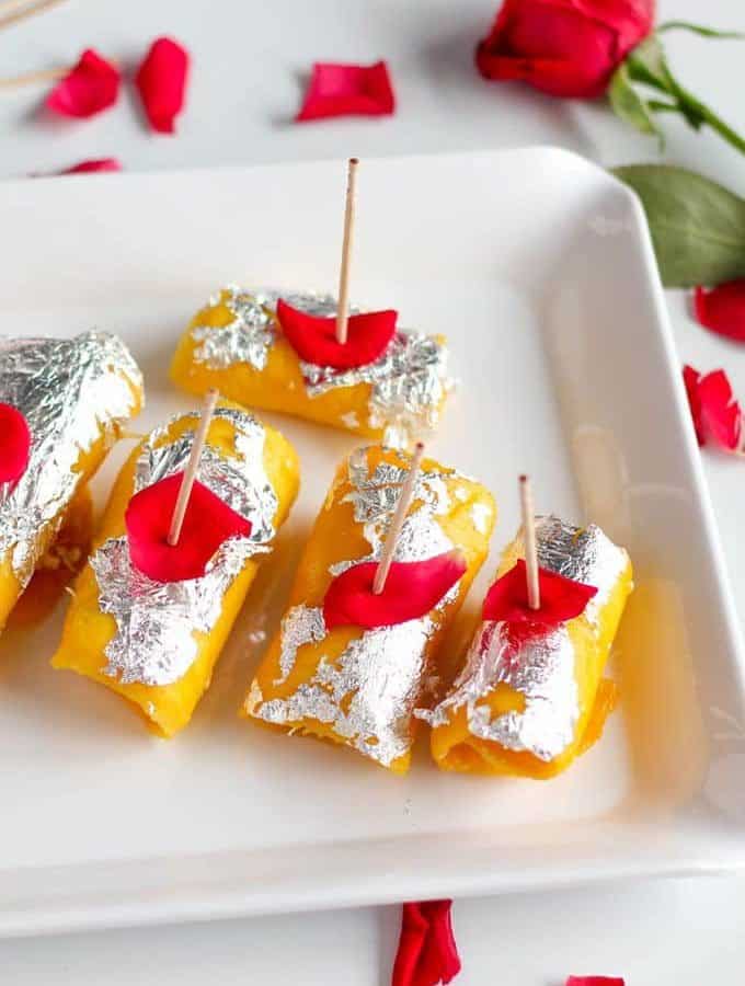Mango Cheese Rolls beautifully decorated with silver leafs and rose petels