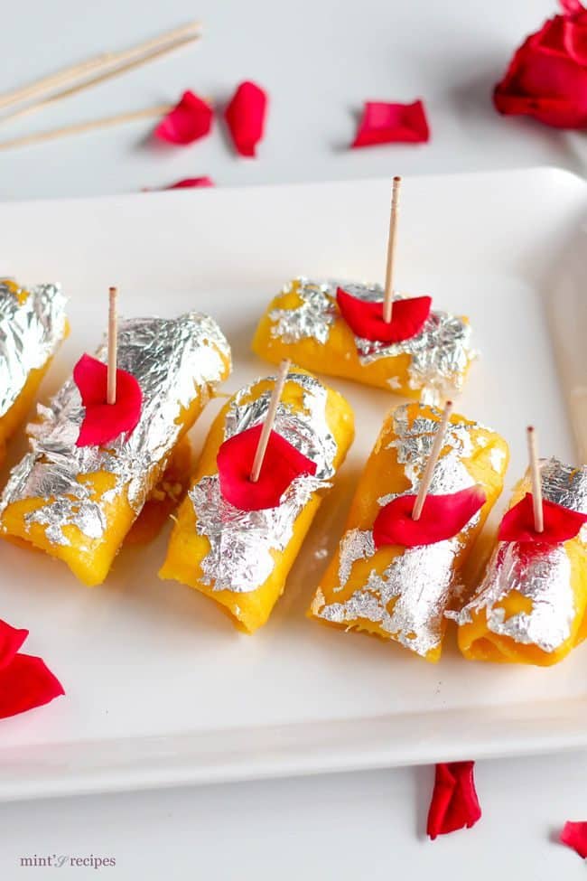 Mango Cheese Rolls beautifully decorated with silver leafs and rose petels 