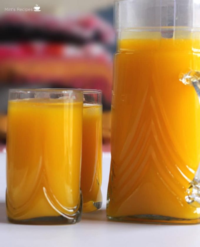 Mango Frooti sweet, thick and smooth mango juice filled in the jug ands glasses with a blur background | 