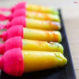 Mango kiwi delight on a black tray with 6 pieces of mango delight |