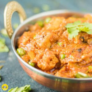 Mixed vegetables on a deep vessel with some coriander leaves.