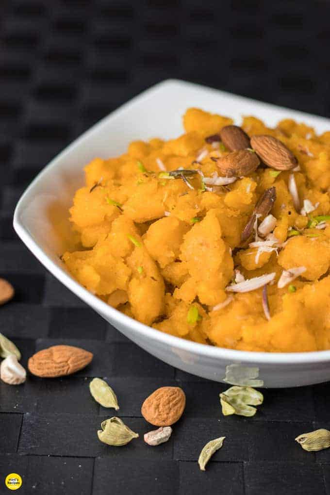 Moongdal ka halwa on a yellow bowl garnished with almonds