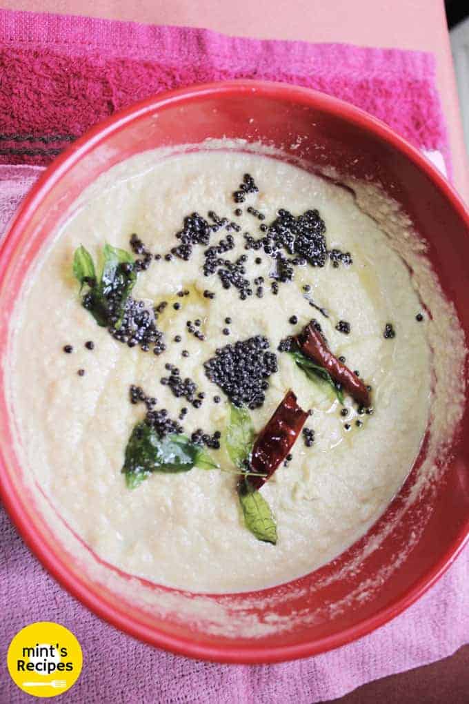 Nariyal Ki Chutney in a red bowl with some tempering