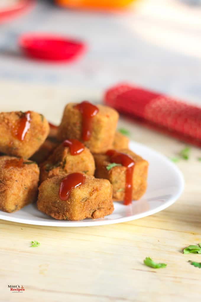 Rava Cutlet with Green chutney served on a white plate