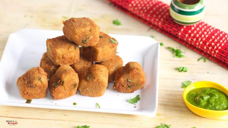 Rava Cutlet with Green chutney served on a white plate