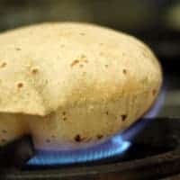 Roti, Chapati, Phulka on a steel plate in the wooden basket |