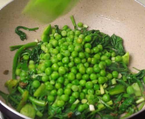 Add spring onion and peas in a pan