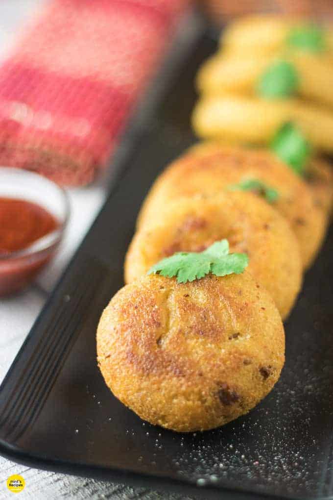 Suji ki kachori on a white plate with some green chutney garnish with coriander leaves