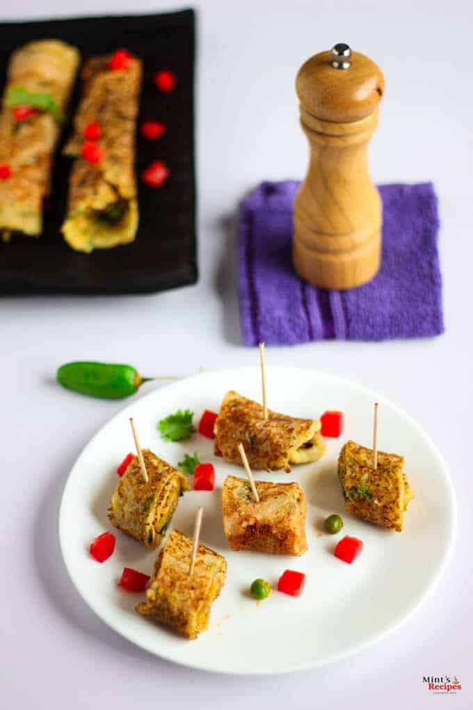 Suji Potato Rolls on a white plate with some chopped veggies | Suji Recipe