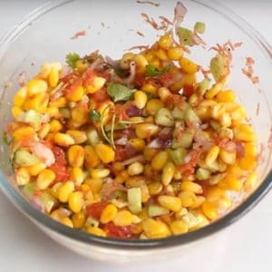 Corn Salad palced on white plate in a bowl