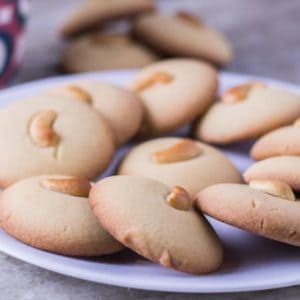 vanilla cookies on a white plate with some cookies