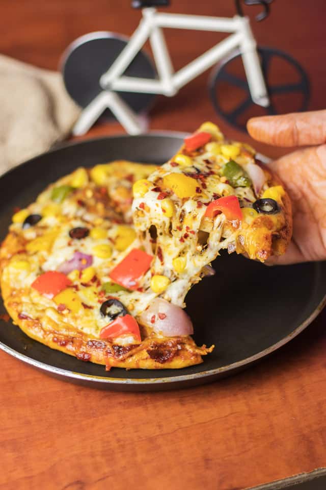 Veg Atta Pizza on a black pan