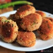 Veg Poha Cutlet on a white cutlet with some poha cutlets and a dark background |