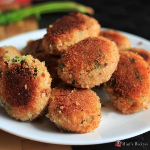 Veg Poha Cutlet on a white cutlet with some poha cutlets and a dark background |