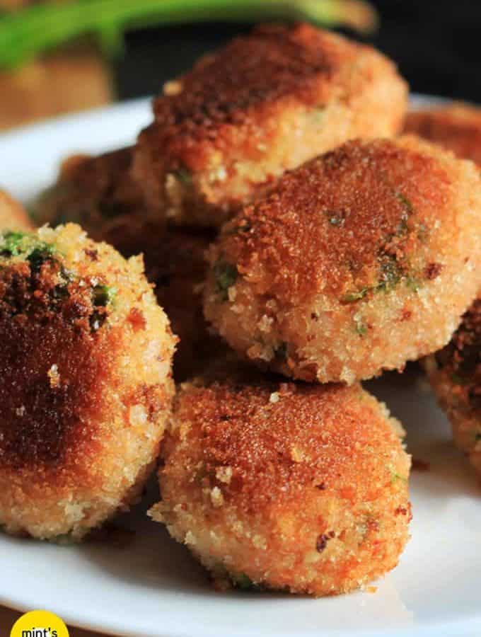 Veg Poha Cutlet on a white cutlet with some poha cutlets and a dark background |