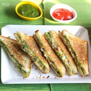 Veg Mayonnaise Sandwich Recipe on a white tray with chilli flakes and some green chutney and tomato ketchup on the background |